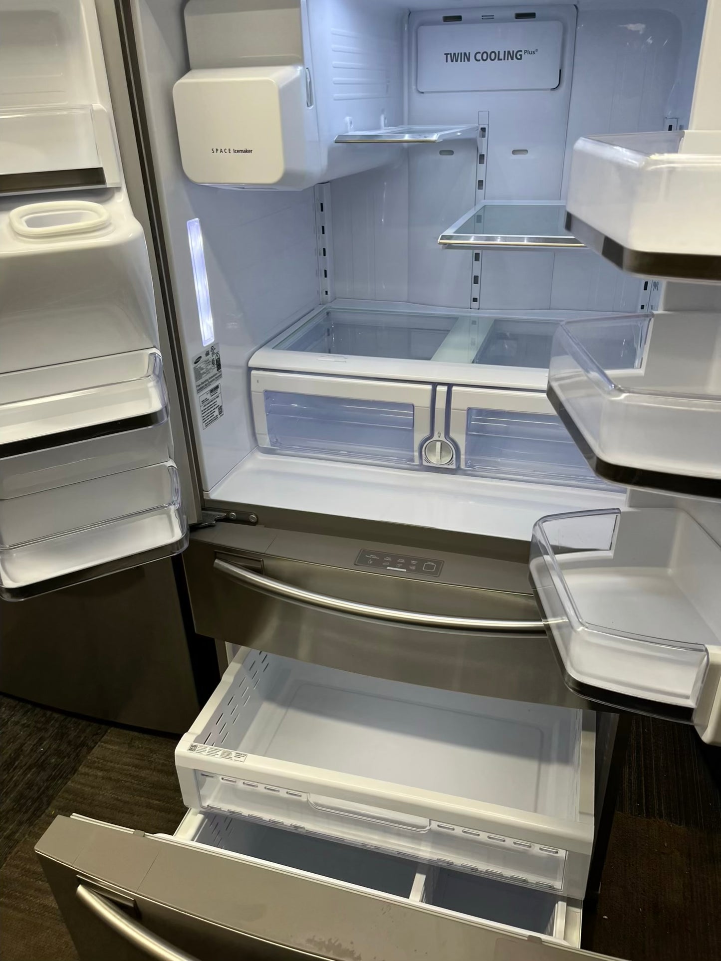 ^ Item #RF29R Samsung four door refrigerator stainless steel w/ ice and water dispenser inside 33’ in