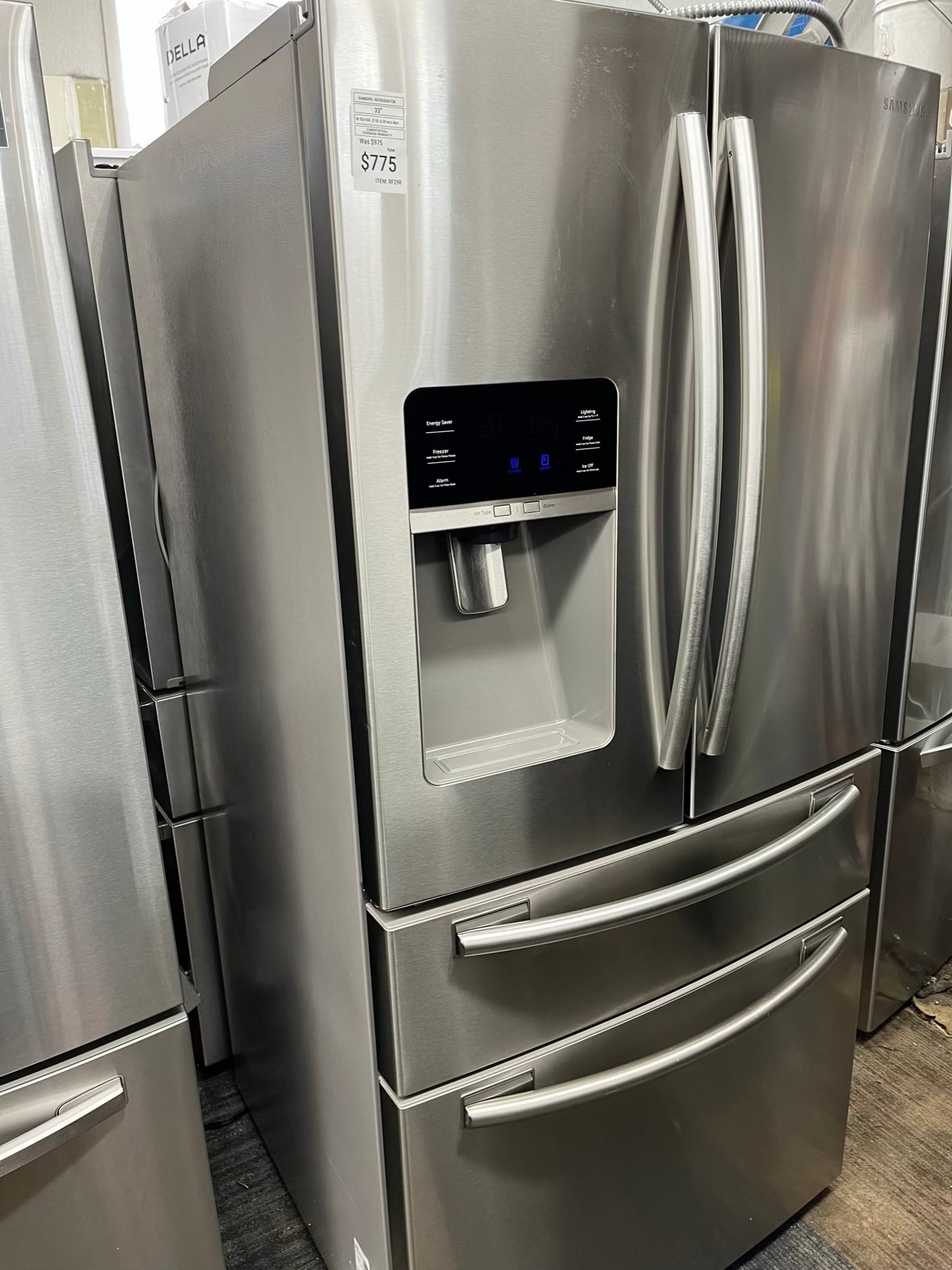 ^ Item #RF29R Samsung four door refrigerator stainless steel w/ ice and water dispenser inside 33’ in